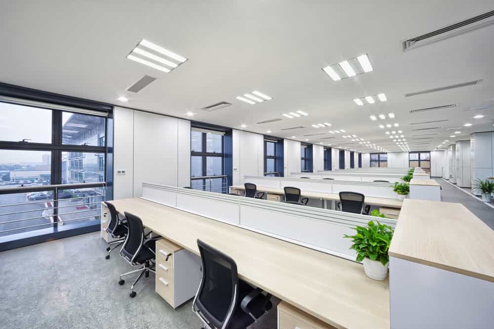 A commercial office renovation idea brought to life, featuring a simple layout of desks and a light and bright colour scheme.