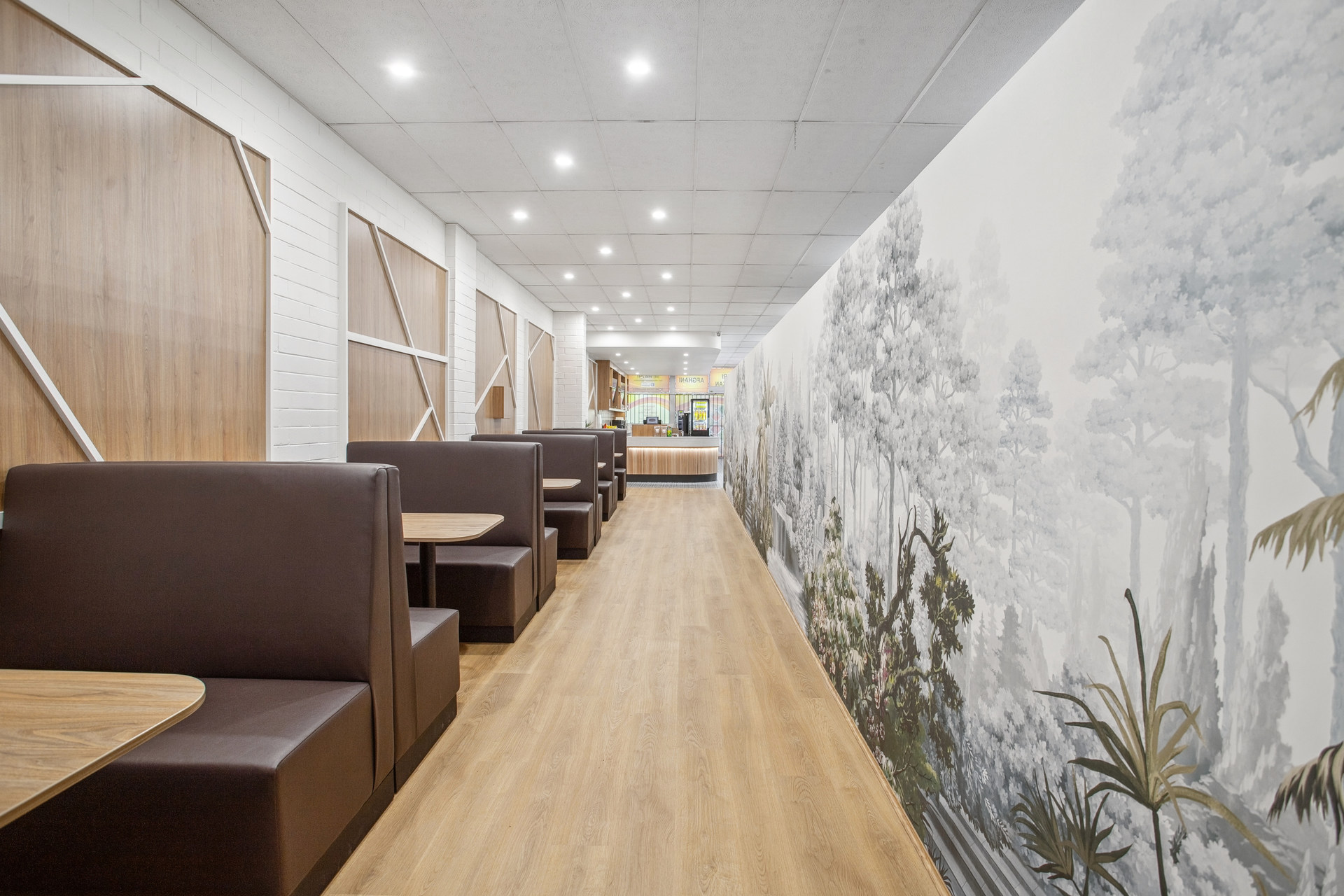 The dining area of Indian Ocean Groceries in Kelmscott Perth, featuring botanical wallpaper