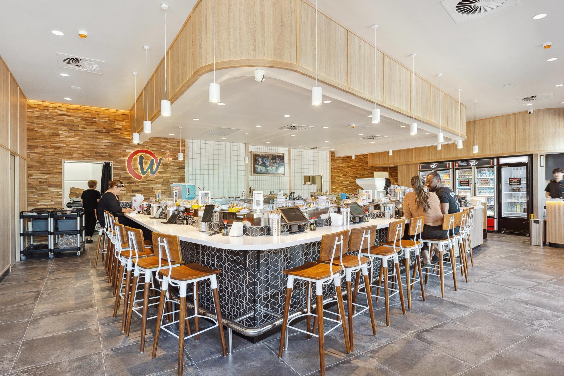 The interior fitout of Wara Sushi in Rockingham featuring seating around a sushi train.