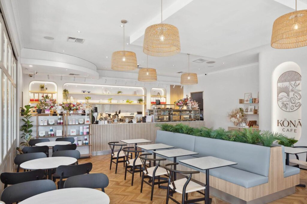 A restaurant featuring a wooden bar, wooden bench seats and large basket lights that was achieved by following a commercial design guide.