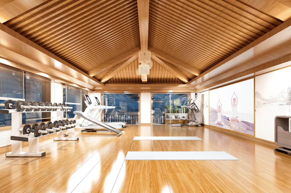 A luxury wood-panelled ceiling in a commercial gym that was achieved by following a commercial design guide.